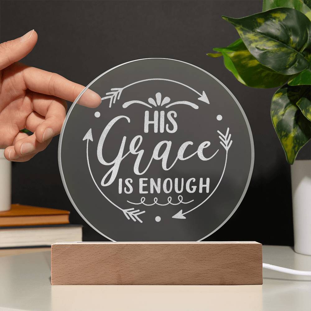 Round clear acrylic plaque with HIS GRACE IS ENOUGH engraved on it with wooden base