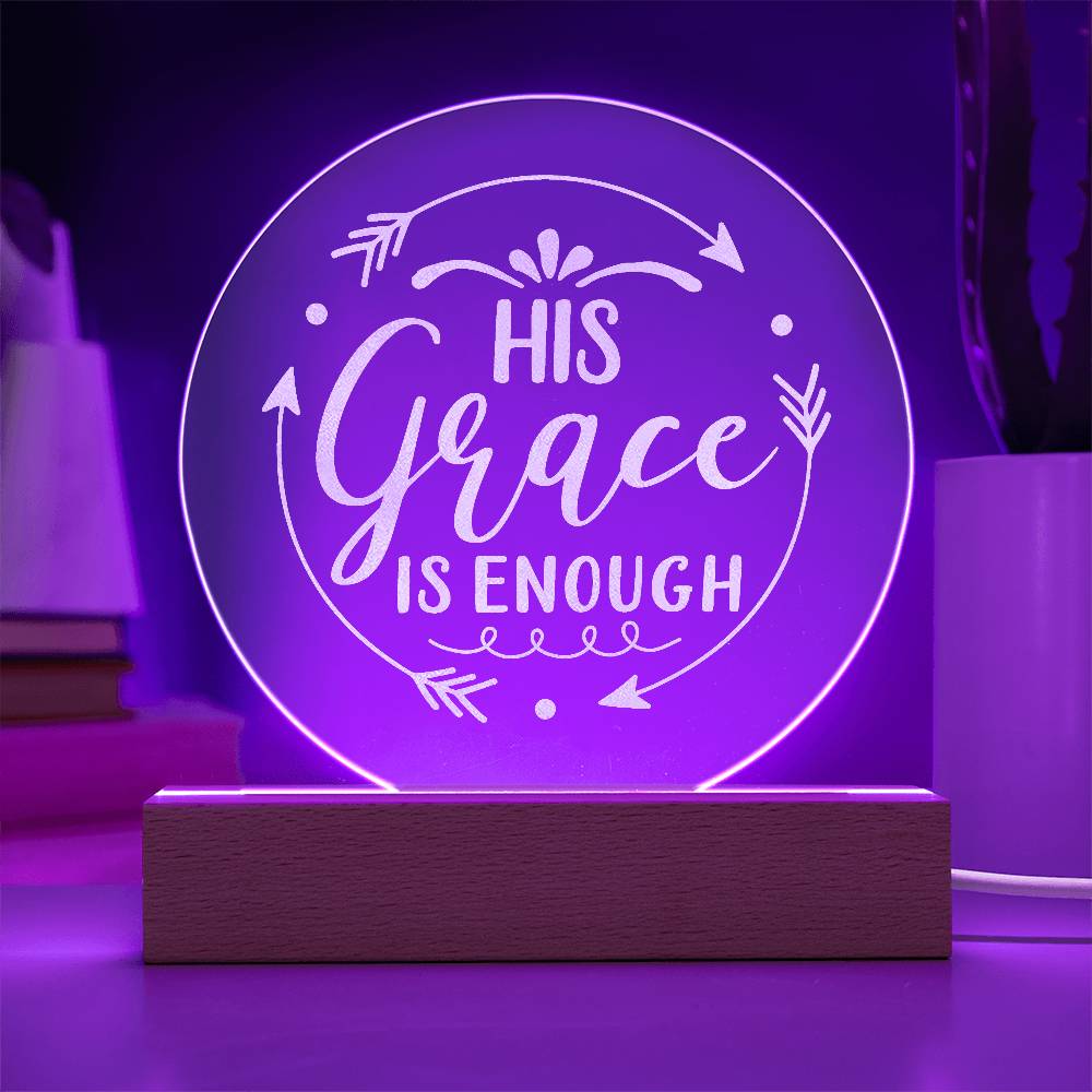 Round clear acrylic plaque with 'His Grace Is Enough' engraved on it. Illuminated with purple LED light