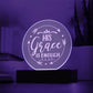 Round clear acrylic plaque with 'His Grace Is Enough' engraved on it. Illuminated with purple LED light